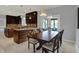 Open-concept dining area with kitchen access and outdoor views at 12535 Glendurgan Dr, Carmel, IN 46032