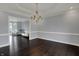 Formal dining room boasts hardwood floors, decorative chandelier, and trim, perfect for entertaining at 12535 Glendurgan Dr, Carmel, IN 46032