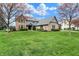 Lovely home featuring a lush green lawn, mature trees, and blooming flower beds at 12535 Glendurgan Dr, Carmel, IN 46032