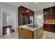 Modern kitchen featuring a cooktop island, granite countertops, and stainless steel appliances at 12535 Glendurgan Dr, Carmel, IN 46032