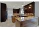 Bright kitchen with granite countertops, cooktop island, stainless steel appliances, and custom cabinetry at 12535 Glendurgan Dr, Carmel, IN 46032