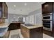 Spacious kitchen featuring a center island with cooktop and double ovens at 12535 Glendurgan Dr, Carmel, IN 46032