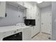 Well-organized laundry room with a sink, storage cabinets and modern machines at 12535 Glendurgan Dr, Carmel, IN 46032