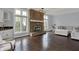Cozy living room with brick fireplace, hardwood floors, and natural light at 12535 Glendurgan Dr, Carmel, IN 46032