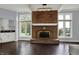 Living room with a large brick fireplace flanked by windows, allowing for lots of natural light at 12535 Glendurgan Dr, Carmel, IN 46032