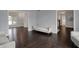 Hardwood floors extend through open room with neutral paint and lovely natural light at 12535 Glendurgan Dr, Carmel, IN 46032