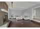 Spacious living room with a fireplace and a comfortable sectional sofa; neutral color palette at 12535 Glendurgan Dr, Carmel, IN 46032