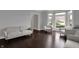Well lit room with hardwood floors and neutral-toned furniture, with large bay window at 12535 Glendurgan Dr, Carmel, IN 46032