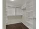 Walk-in closet with custom shelving and wooden floors provides ample storage space at 12535 Glendurgan Dr, Carmel, IN 46032