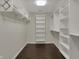 Spacious walk-in closet provides ample storage with custom shelving and racks at 12535 Glendurgan Dr, Carmel, IN 46032