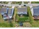 Aerial view of a backyard with green grass, wood fence, and patio area with table and seating at 1279 Windswept Dr, Greenwood, IN 46143
