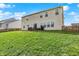 Spacious backyard with green grass, wood fence, and a concrete patio area with table and seating at 1279 Windswept Dr, Greenwood, IN 46143