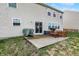 Backyard patio with a grill, outdoor furniture, and sliding door access into the tan vinyl-sided home at 1279 Windswept Dr, Greenwood, IN 46143