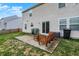 Backyard patio featuring a table and bench seating, grill with cover, and sliding door to home at 1279 Windswept Dr, Greenwood, IN 46143