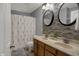 Bathroom featuring dual sinks, decorative mirrors, and a shower with a floral curtain at 1279 Windswept Dr, Greenwood, IN 46143