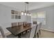 Bright dining room features modern lighting, decor and seating for eight at 1279 Windswept Dr, Greenwood, IN 46143
