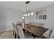 Bright dining room features modern lighting, decor and seating for eight at 1279 Windswept Dr, Greenwood, IN 46143