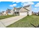 Suburban two-story home with brick and vinyl siding, an attached two-car garage, and a neatly manicured front lawn at 1279 Windswept Dr, Greenwood, IN 46143