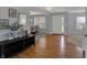 Light and airy foyer featuring hardwood floors, neutral gray paint, and an adjacent dining room at 1279 Windswept Dr, Greenwood, IN 46143