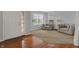 Cozy living room with neutral carpet, front door, and plenty of natural light from the nearby windows at 1279 Windswept Dr, Greenwood, IN 46143