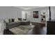 Cozy living room with hardwood floors, comfortable sectional sofa, and large windows at 1279 Windswept Dr, Greenwood, IN 46143