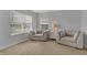 Bright living room with neutral carpet, natural lighting and two matching armchairs at 1279 Windswept Dr, Greenwood, IN 46143