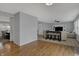 Open concept living area with hardwood floors connecting living, dining, and kitchen spaces at 1279 Windswept Dr, Greenwood, IN 46143
