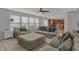 Cozy living room with modern furniture and a ceiling fan is open to the kitchen at 1279 Windswept Dr, Greenwood, IN 46143