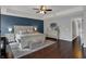 Serene main bedroom with tray ceilings, a king bed, a dresser, and en-suite bathroom at 1279 Windswept Dr, Greenwood, IN 46143