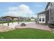 This backyard features a in-ground pool, gazebo, firepit, built-in grill, and beautiful green grass at 12988 Fernie Cir, Fishers, IN 46037