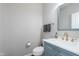 A stylish powder room featuring a vanity with gold fixtures and patterned hand towels at 12988 Fernie Cir, Fishers, IN 46037
