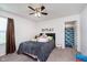 Comfortable bedroom featuring a bed, ceiling fan, and attached bathroom with a shark-themed shower curtain at 12988 Fernie Cir, Fishers, IN 46037