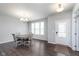 Bright dining room with wood table and modern chandelier at 12988 Fernie Cir, Fishers, IN 46037