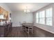 Elegant dining room with wooden table and chandelier fixture at 12988 Fernie Cir, Fishers, IN 46037