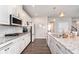Gourmet kitchen featuring granite counters, white cabinets and modern backsplash at 12988 Fernie Cir, Fishers, IN 46037