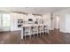 Bright kitchen features a large island with bar seating and sleek white cabinetry at 12988 Fernie Cir, Fishers, IN 46037