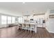 Open-concept kitchen with island seating, white cabinets and stainless appliances at 12988 Fernie Cir, Fishers, IN 46037