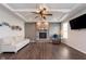 Cozy living room with stone fireplace, neutral decor and hardwood floors at 12988 Fernie Cir, Fishers, IN 46037