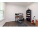 This home office features hardwood floors, a desk, and shelving for a functional workspace at 12988 Fernie Cir, Fishers, IN 46037