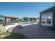 Stamped concrete patio area with pool, gazebo, and a stone fire pit at 12988 Fernie Cir, Fishers, IN 46037