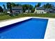 An in-ground pool surrounded by backyard with grassy areas and a play set in the distance at 12988 Fernie Cir, Fishers, IN 46037