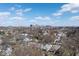 Expansive neighborhood aerial view of homes with a city skyline backdrop on a sunny day at 1351 S Belmont Ave, Indianapolis, IN 46221