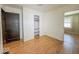 Empty room with light wood floors and a dark wood door, ready for a new design at 1351 S Belmont Ave, Indianapolis, IN 46221