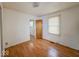 A compact bedroom with light wood floors and a bright window, ideal for a minimalist setup at 1351 S Belmont Ave, Indianapolis, IN 46221