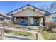 Charming single-story home with a covered front porch, ramp, and updated siding at 1351 S Belmont Ave, Indianapolis, IN 46221