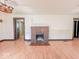 Spacious living room featuring a vintage-style chandelier and a brick fireplace at 1351 S Belmont Ave, Indianapolis, IN 46221