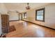Spacious living room featuring hardwood floors, a brick fireplace, and ample natural light at 1351 S Belmont Ave, Indianapolis, IN 46221