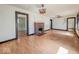 Large living room with original hardwood floors and a charming brick fireplace at 1351 S Belmont Ave, Indianapolis, IN 46221