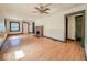 Sunny living room featuring a vintage ceiling fan, a brick fireplace, and an expansive view at 1351 S Belmont Ave, Indianapolis, IN 46221