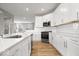 Well-equipped kitchen with white cabinetry, stainless steel appliances, and hardwood floors at 13833 Tender Dr, Carmel, IN 46032
